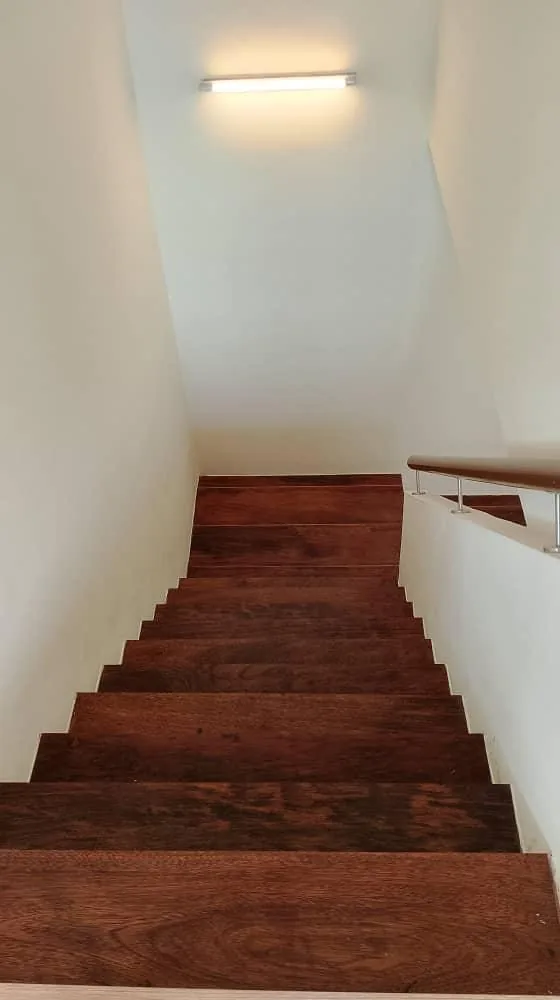 Dark wood staircase downward view