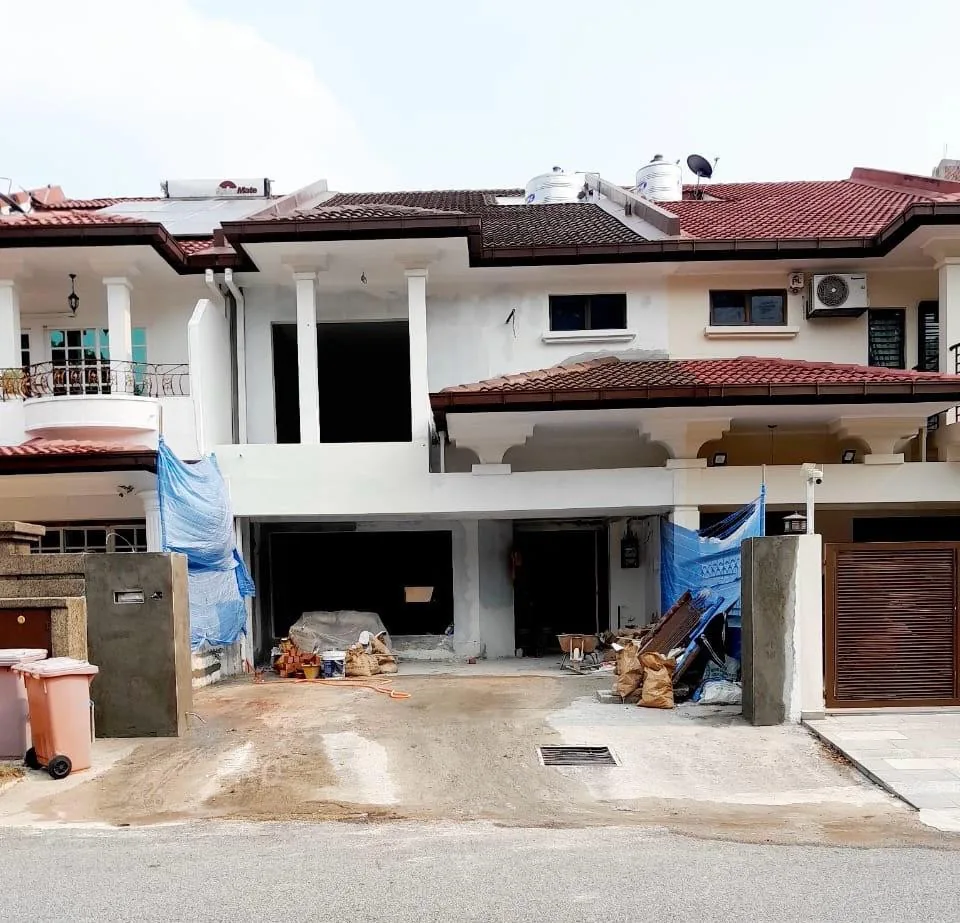 Two-storey terrace house under renovation in Bandar Utama, showing the front facade and driveway.