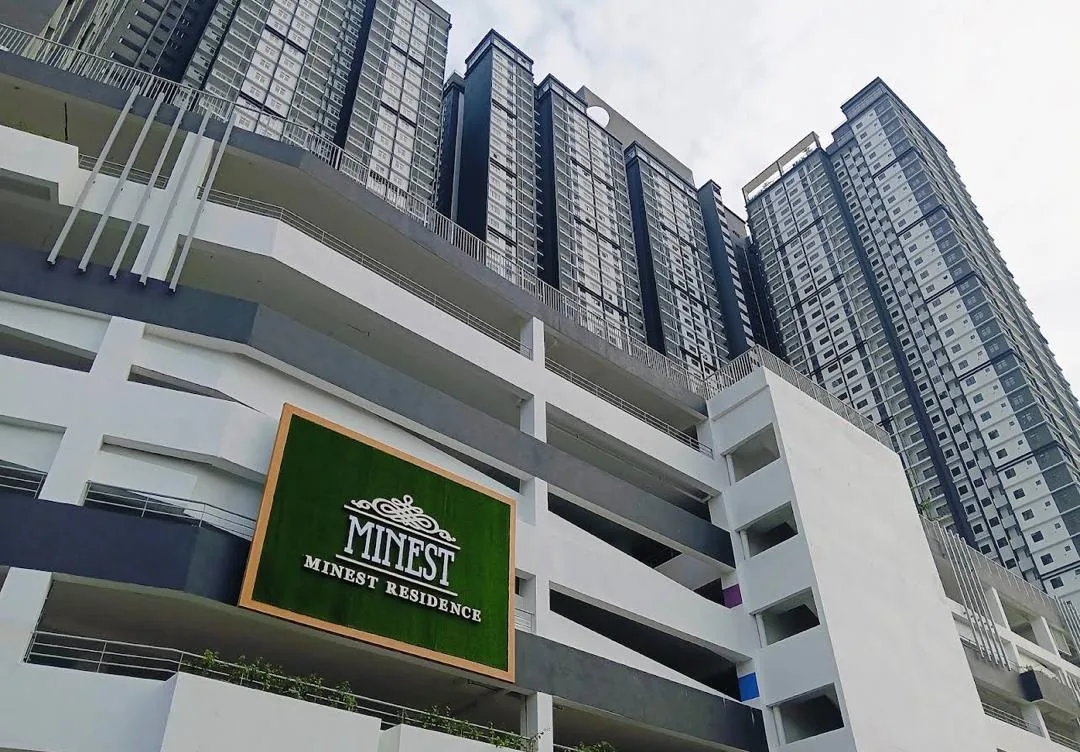 Minest Residence signboard on the building, with the condominium towers behind